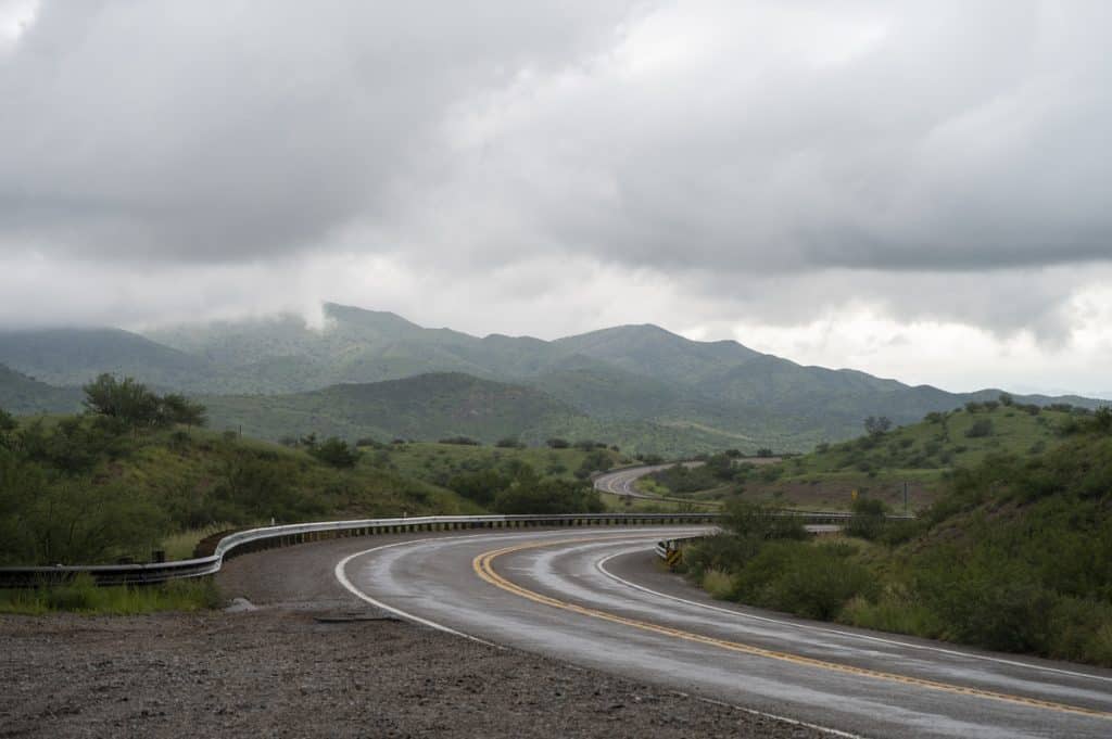 highway 83 in southern arizona winding through green mountains and low clouds