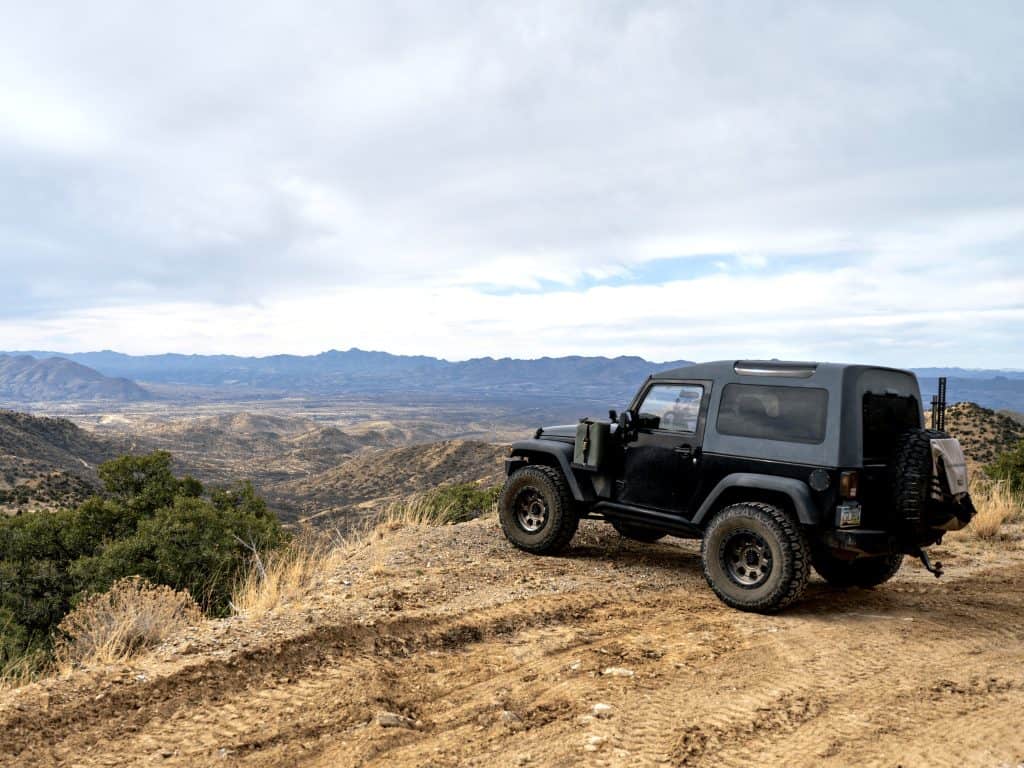 This Winding Road In Southern Arizona Takes You To A World-Class Observatory 9 black jeep wrangler parked on mount hopkins road in southern arizona overlooking mountainous landscape