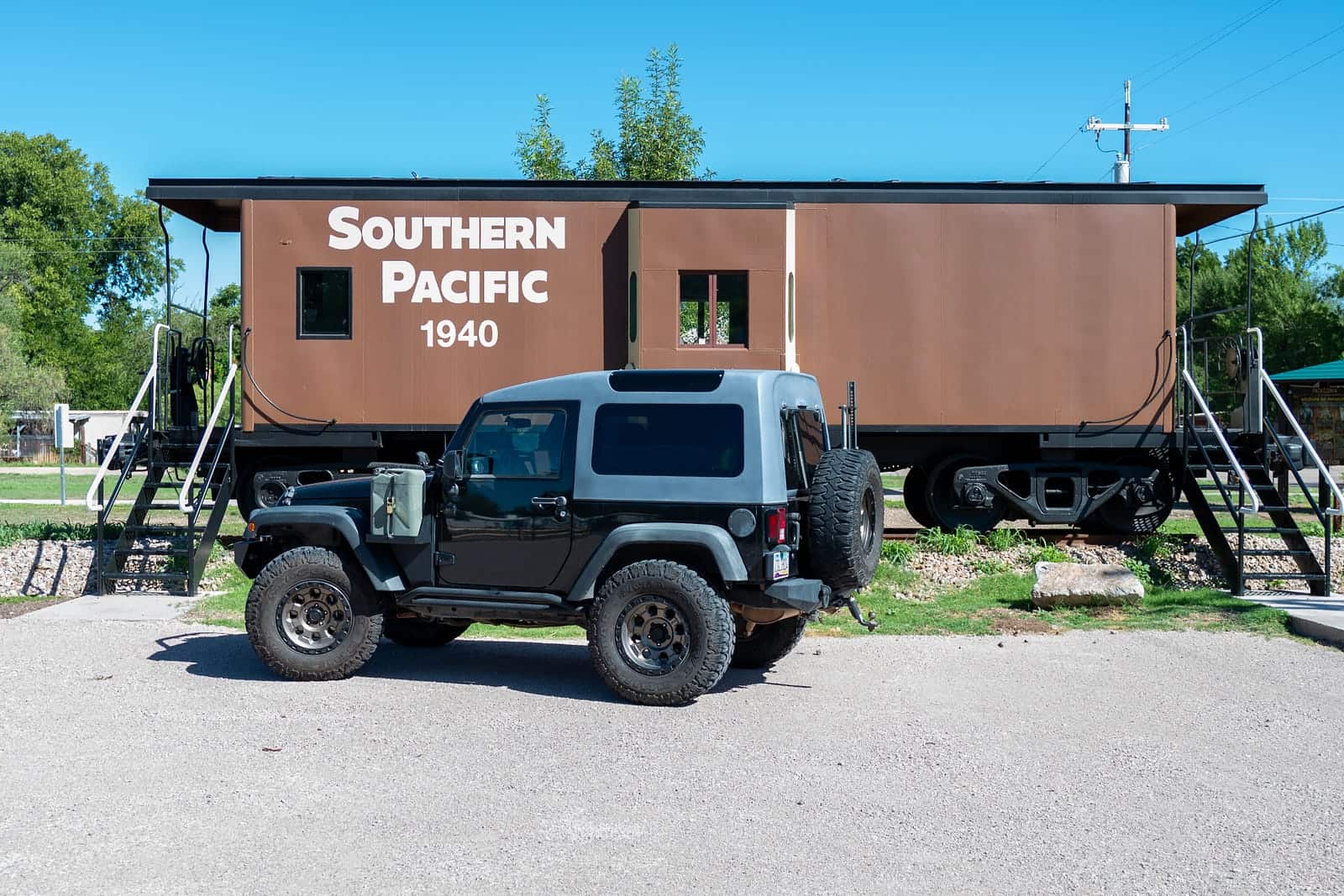 jeep parked in front of an old train car turned visitors center in patagonia, arizona