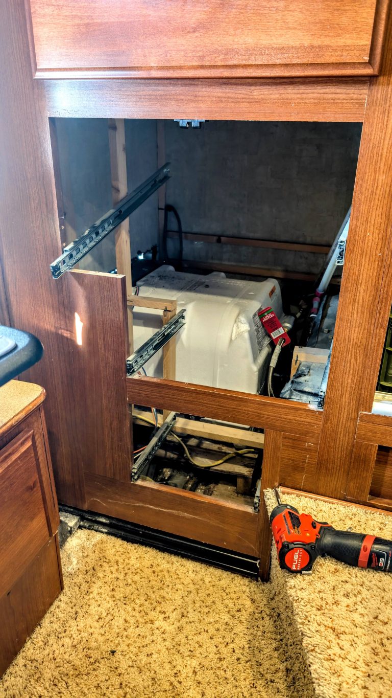 Our Rv Water Heater Failed (Again), So We Went Tankless 6 open compartment revealing rv water heater